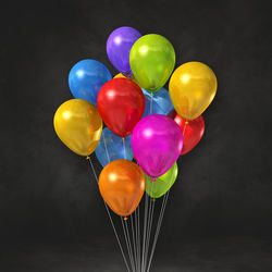 Close-up of multi colored balloons against black background