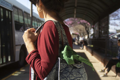 Rear view of woman standing in city