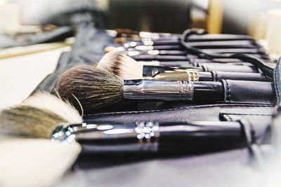 Close-up of make-up brushes on table