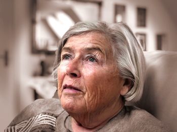 Close-up of senior woman at home