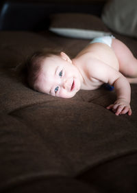 Portrait of cute baby lying on bed