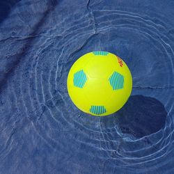 Close-up of yellow ball on beach