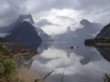 Scenic view of lake and mountains against sky