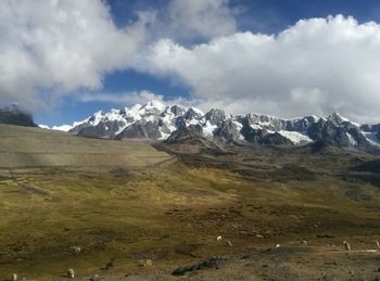 Scenic view of mountains against cloudy sky