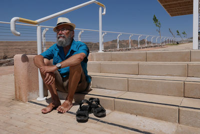 Portrait of senior man sitting on steps outdoor 