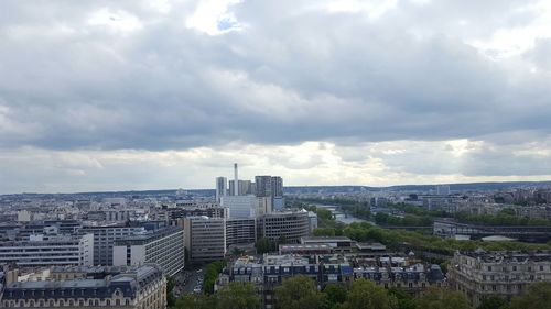 View of cityscape against cloudy sky
