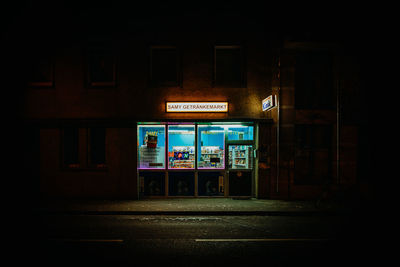 Illuminated sign on road at night