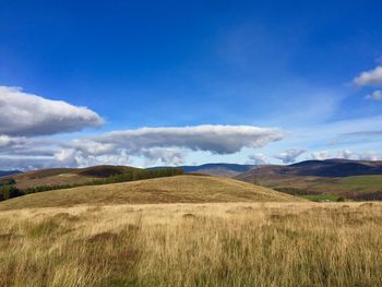 View of countryside landscape against cloudy sky