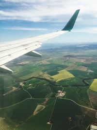 Cropped image of airplane flying over landscape