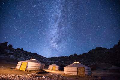 Scenic view of illuminated mountains against sky at night