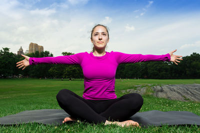 Woman practicing yoga at park