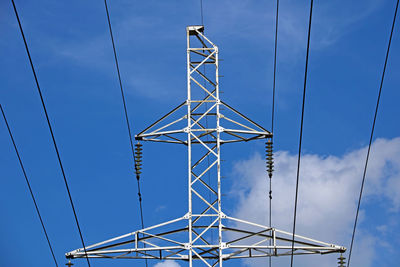 Low angle view of electricity pylon against sky