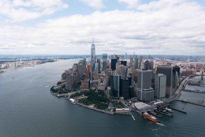 Panoramic view of bay and buildings against sky