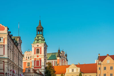 View of buildings against clear blue sky