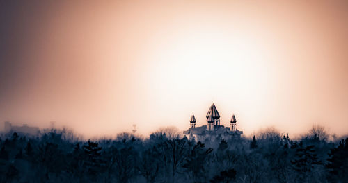 Snow covered field at sunset