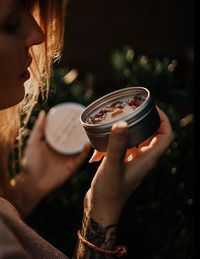 Midsection of woman holding candle 