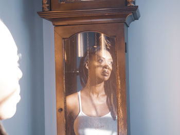  reflecting of a beautiful young women in a grandfather clock portrait of woman 