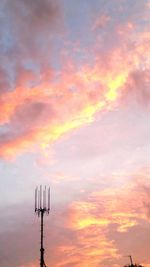 Low angle view of silhouette crane against sky during sunset