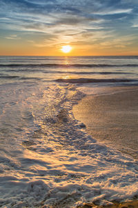 Scenic view of beach against sky during sunset
