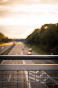 Close-up of highway against sky during sunset
