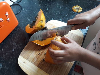 High angle view of person preparing food on cutting board