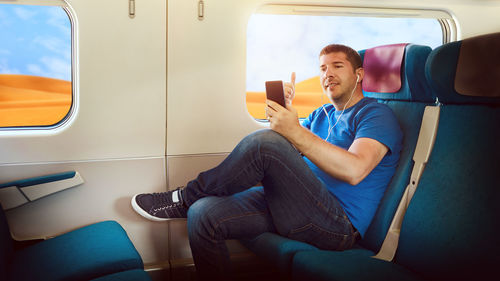 Young man sitting in bus