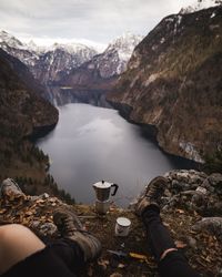 Scenic view of lake by mountains against sky