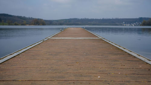 Pier over lake against sky