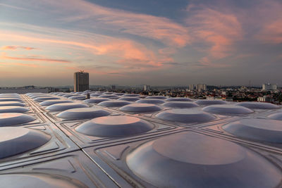 Aerial view of buildings against sky during sunset