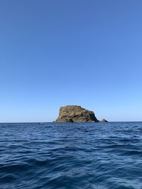 Scenic view of sea against clear blue sky