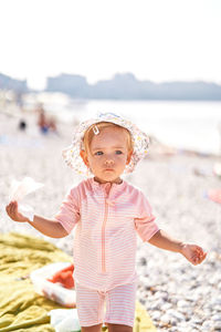 Portrait of cute girl standing at beach