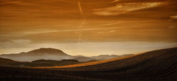 Scenic view of dramatic sky over landscape