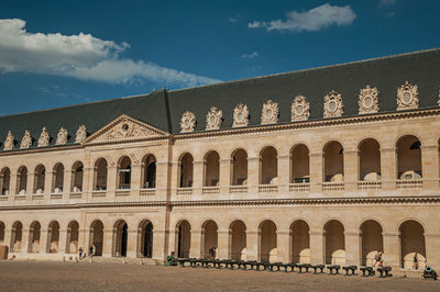 Inner courtyard of the les invalides palace with old cannons in paris. the famous capital of france.