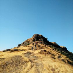 Low angle view of mountain against clear blue sky