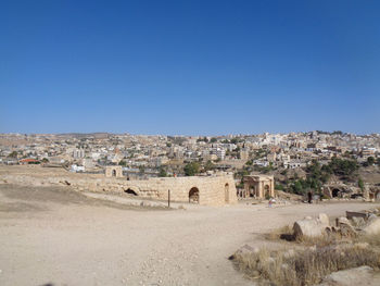 Panoramic view of old building in city against clear blue sky