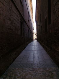 Walkway amidst city buildings