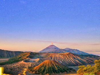 Scenic view of mountain range against blue sky