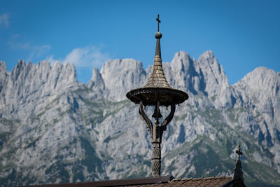 Panoramic view of cross on mountain against sky