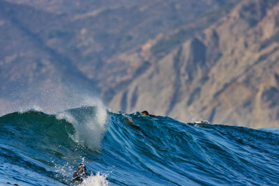 Waves splashing on rocks against sea