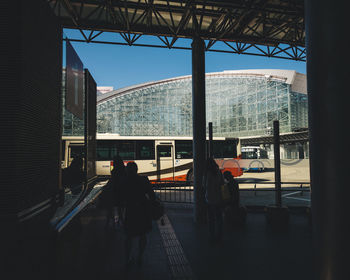 Rear view of people on glass window of building