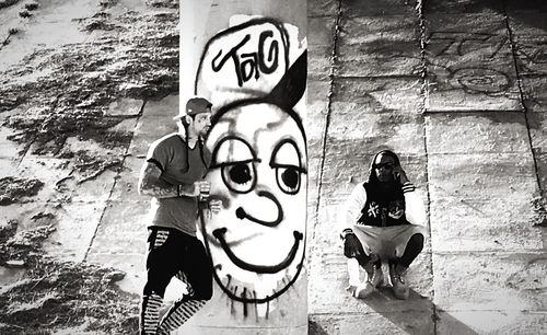 Man standing against graffiti wall