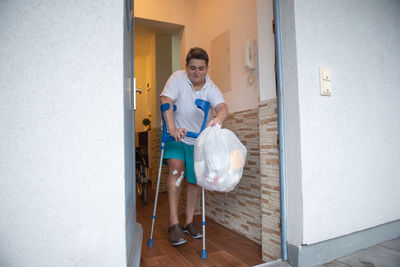 A disabled person takes out garbage