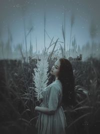 Side view of woman looking away on field