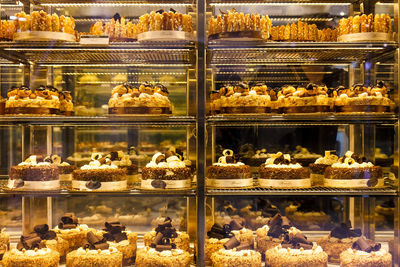 Cakes arranged on shelves at shop