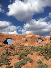 View of rock formations against cloudy sky