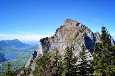 Scenic view of mountains against blue sky