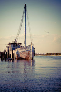 Commercial dock by sea against sky