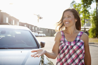 Happy woman throwing keys in the air