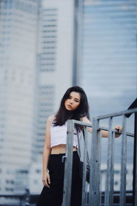 Portrait of woman standing in city