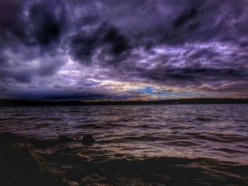 Scenic view of sea against cloudy sky